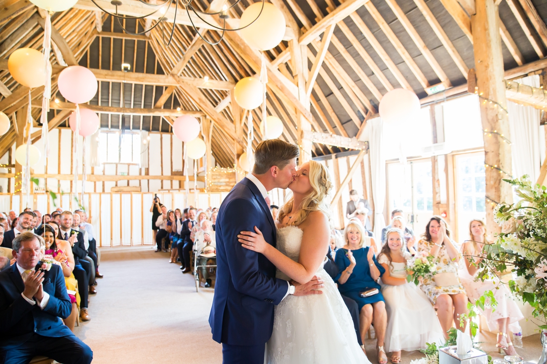clock barn wedding - first kiss