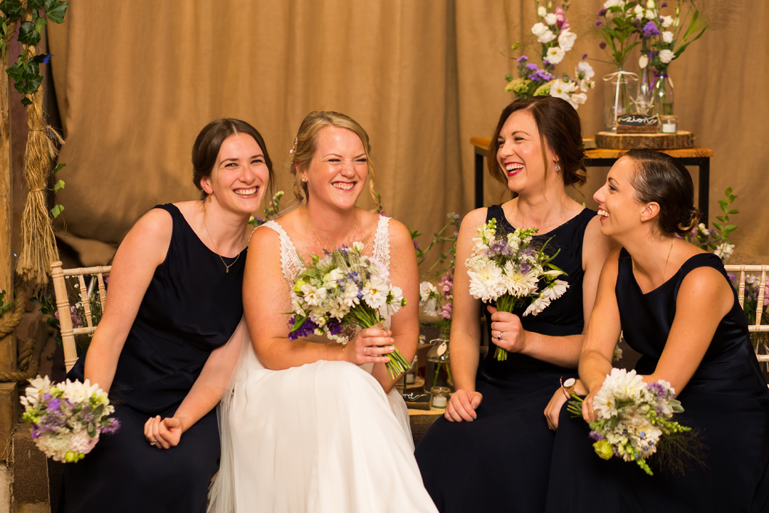 relaxed bride and bridesmaid group wedding photo