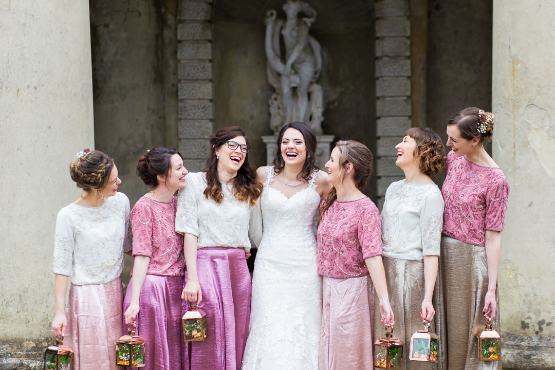 bride and bridemaids laughing in fun group wedding photo at Wooton House