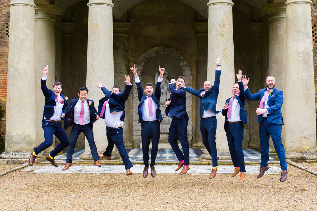 groom and groomsmen jumping for fun group wedding photo